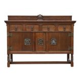Arts and Crafts oak sideboard, with carved castellated backboard over two drawers and cupboard doors