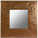 A hammered copper wall mirror, hammered and grape vines, 56cm x 56cm and a 1920's mirror with