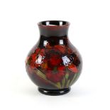 Moorcroft vase of baluster form tube-lined and decorated in colours with irises and geraniums,