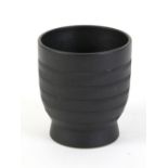 Keith Murray for Wedgwood black basalt vase of cylindrical form with herringbone decoration, on a