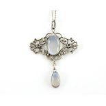 An Arts & Crafts pendant set with a large moonstone and a pear form moonstone drop, on a silver