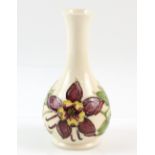 Moorcroft pottery white ground vase decorated with flowers, impressed mark, 16cm high,.