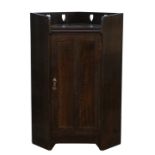 Liberty & Co, oak floor standing oak corner cabinet, with pierced heart motif, single door,