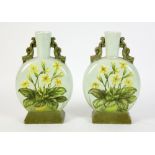 A pair of Aesthetic movement bottle vases, dolphin handles, the body painted with primula, the