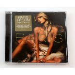 § Banksy (British, born 1974). 'Paris Hilton', 2006, customised CD and case, 12.5 x 14.5cm. One from