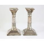 Elizabeth II pair of silver dwarf candlesticks, each of Corinthian column form, on filled stepped