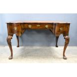 A mahogany writing desk with leather top and cabriole legs..