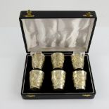 Set of six sterling silver tot cups, embossed with safari scenes, cased, each 5.5 cm high, 149 gr. .