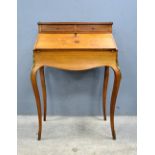 French style walnut bureau with inlaid decoration on brass mounted cabriole legs,.