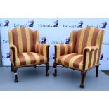 Pair of 19th century style mahogany framed wing back arm chairs .