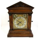 An oak two train mantel clock the silvered dial stamped Goldsmiths and Silversmiths, two