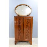 Oak hall stand, oval mirror and a mahogany cupboard .