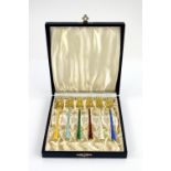 Danish set of six silver-gilt and enamel pickle forks, in fitted case, stamped 925 .