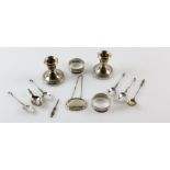 Selection of silver items to include a pair of dwarf candlesticks, two napkin rings, decanter