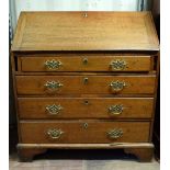 19th century oak fall front bureau with fitted interior above four drawers 103cm x 77cm . Flap rests