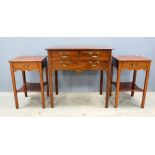 Mahogany side table with three drawers and apir of bedside tables .