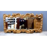 Carved wood wall mirror in the Rococo style..