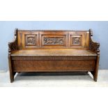 Early 20th century carved oak bench .