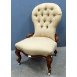 Victorian walnut button backed nursing chair on carved cabriole legs,.