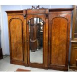 19th century mahogany triple wardrobe, with central mirrored door flanked by panel doors on plinth