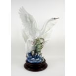 A large Lladro group figure 'Swans Take Flight' (5912), raised on circular wooden plinth, overall