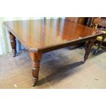 Victorian mahogany extending dining table with two leaves..