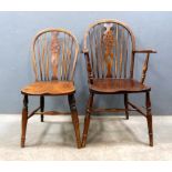 Set of eight oak wheel back dining chairs .