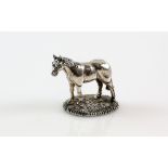 Silver miniature model of a horse, with filled base, stamped 925, 5.5 cm high.