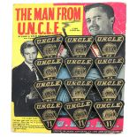 The Man From U.N.C.L.E. - 12 x Black & Gold triangular '11' badges from 1965 by Lone Star, on