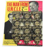 The Man From U.N.C.L.E. - 12 x Black & Gold triangular '2' badges from 1965 by Lone Star, on card,