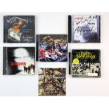 CD albums signed by The International Swingers featuring Glen Matlock and Clem Burke, Travis, The