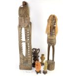 A collection of oriental and tribal artefacts including soapstone figures and two half-size tribal