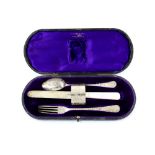 George V silver christening set, comprising fork, spoon, mother-of-pearl handled knife and napkin