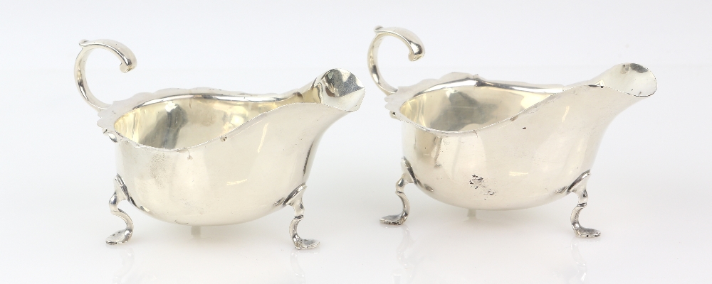 Pair of George V silver sauce boats, with wavy rims on three shaped feet, by Robert Stewart, London, - Image 2 of 4