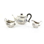 Victorian silver three piece tea service, comprising teapot, cream jug and sugar bowl, with half-