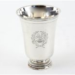 Early 19th century French silver beaker, the tapering plain body chased with a crest, on stepped
