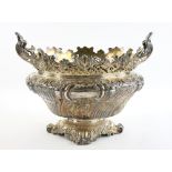 Victorian silver jardiniere with embossed scrolling and foliate decoration, on four scroll feet,
