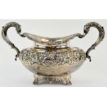 Victorian Irish silver sugar bowl, the squat upper-body chased with flowers and scrolls in high