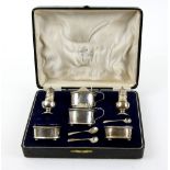 George V silver cruet set, in fitted case, comprising two each of mustard pots and liners, salts and