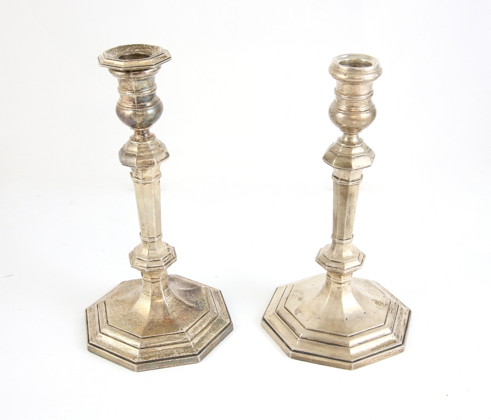Pair of modern silver candlesticks with fluted columns and knopped stems on octagonal bases, by