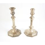 Pair of modern silver candlesticks with fluted columns and knopped stems on octagonal bases, by