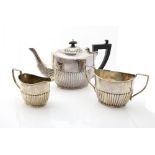 George V silver three-piece tea-service, with gadrooned lower bodies, comprising teapot, milk jug