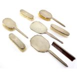 George VI silver backed part dressing table set, comprising three brushes and hand mirror, with