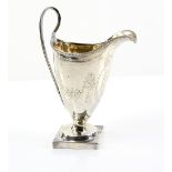 George III silver helmet shaped cream jug, with bright cut decoration, on square foot, by John