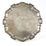 Modern silver presentation salver with pie crust rim on three scroll feet, by Viner's Ltd.,