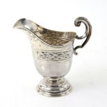 Edward VII Irish silver cream jug with Celtic knotwork decoration, on round foot, maker's mark 'JS',