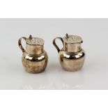 Two Victorian silver Guernsey milk jug style pepperettes, by Cornelius Desormeaux Saunders & James