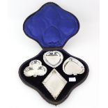 Victorian silver set of four dishes, each in the shape of a suit of playing cards, with flared rims,