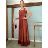 1930's evening dress richly decorated with gilt thread on soft red ground, Sweetheart neck,