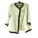 A pale green silk blouse hand embroidered with floral sprigs and later velvet braiding, fabric